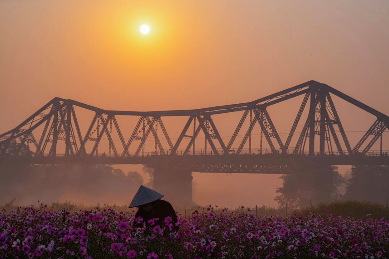 Long Bien Bridge at sunrise, Hanoi, view over Red River toward Old Quarter