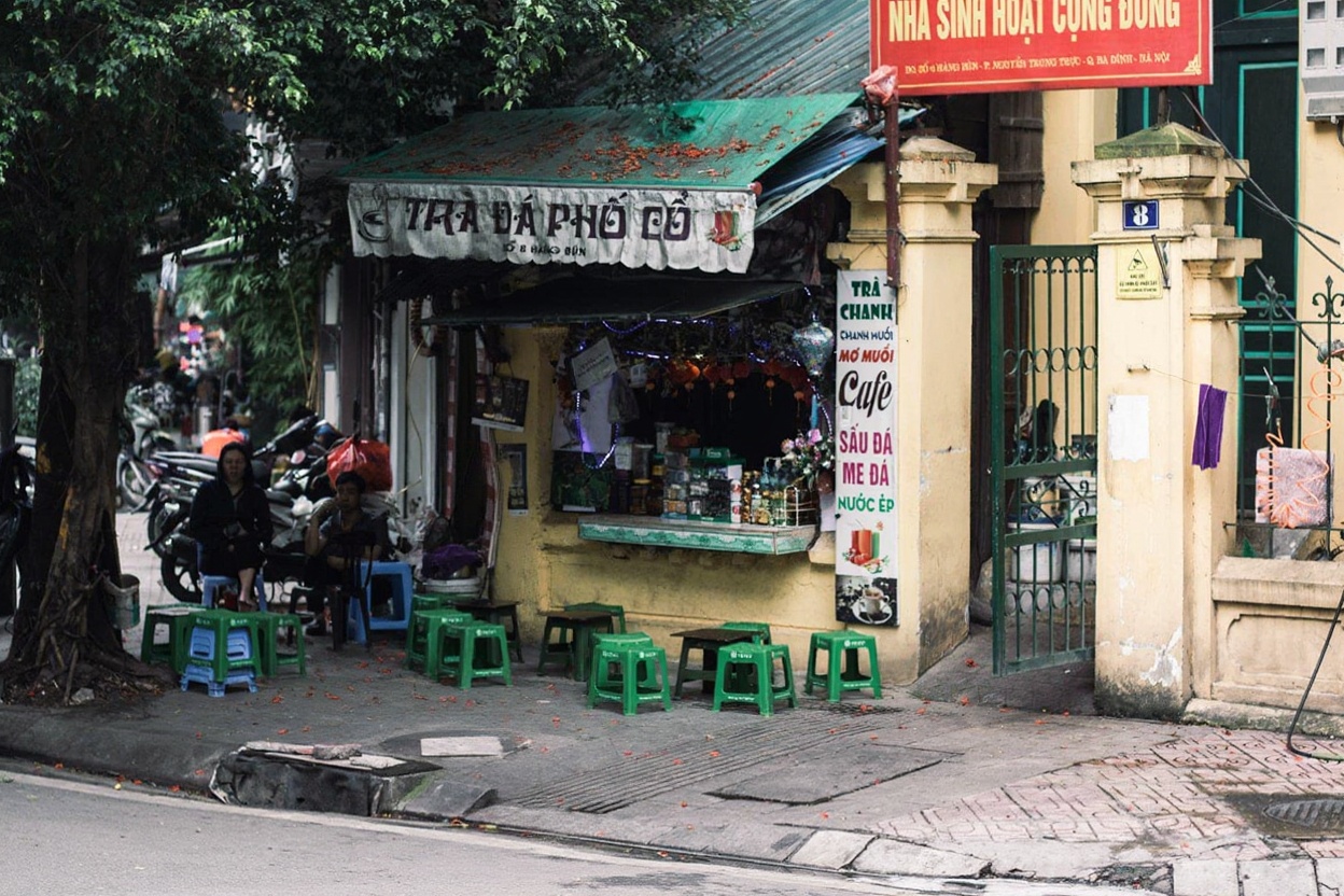 Street-level café culture in Hanoi — coffee, plastic stools, no hurry, every morning