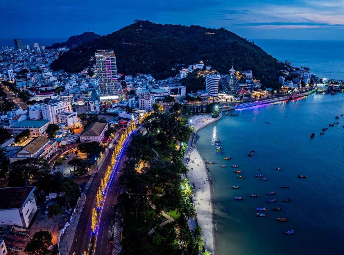 Vũng Tàu's headland — the Jesus statue visible from the water, oil tankers visible from the beach